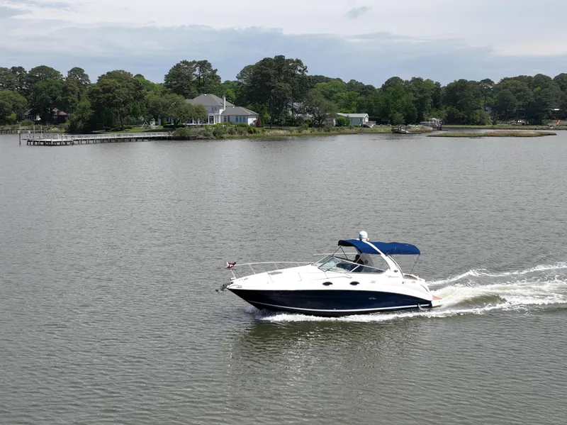 Slide: The Image of 2008 Sea Ray 280 Sundancer cruising on a calm lake with scenic shoreline. - 42