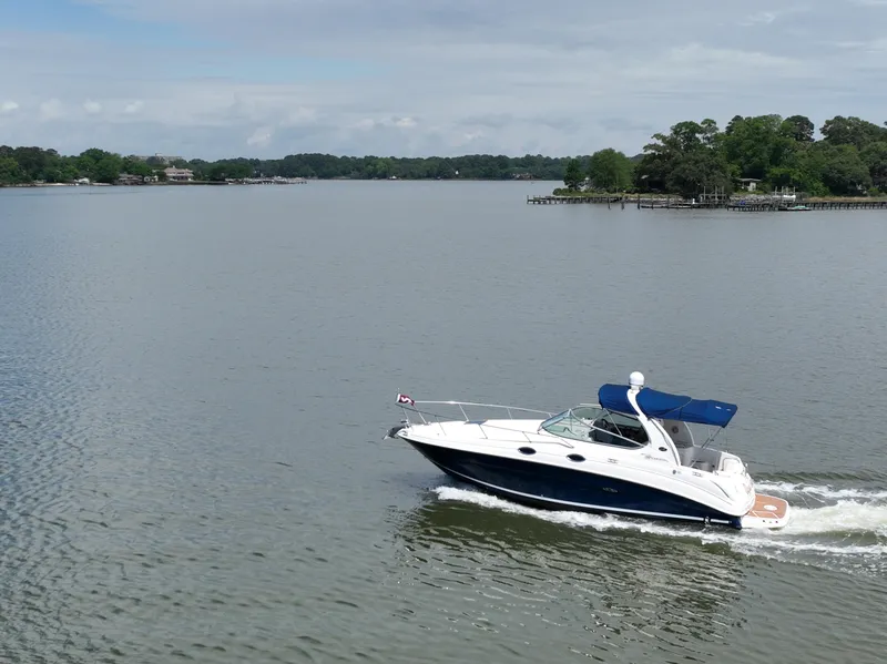 Slide: The Image of 2008 Sea Ray 280 Sundancer cruising on a calm lake with scenic shoreline. - 43