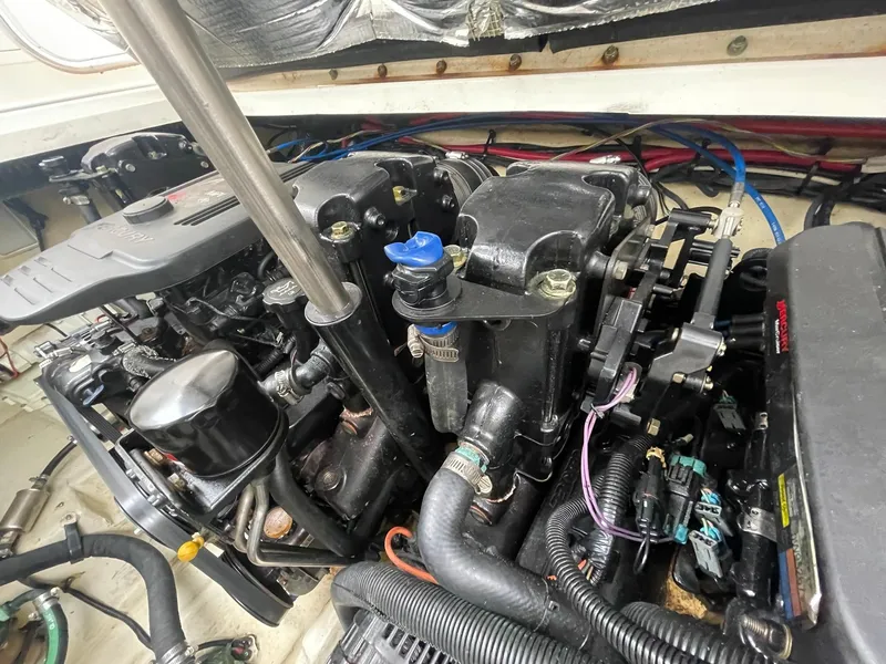 Slide: The Image of Engine compartment of a 2008 Sea Ray 280 Sundancer boat, showcasing detailed components. - 44
