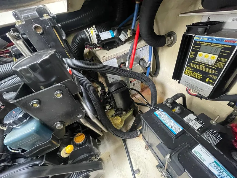 Slide: The Image of Engine compartment of a 2008 Sea Ray 280 Sundancer, showcasing mechanical components and wiring. - 46