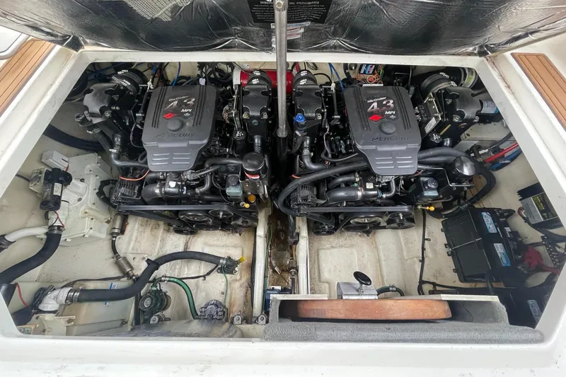 Slide: The Image of Engine compartment of 2008 Sea Ray 280 Sundancer with dual engines and mechanical components. - 48