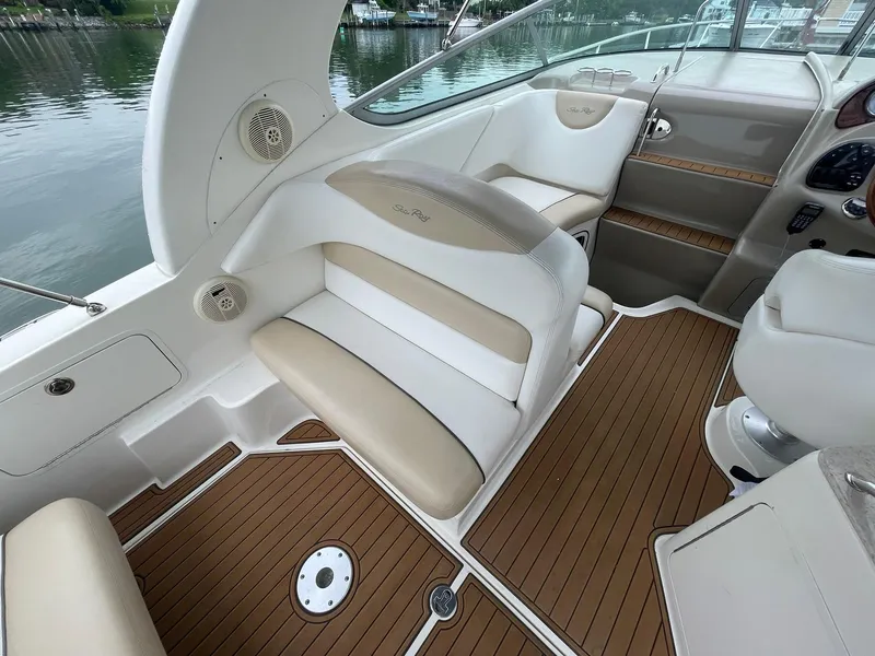 Slide: The Image of 2008 Sea Ray 280 Sundancer interior with beige seating and wood-style flooring. - 6