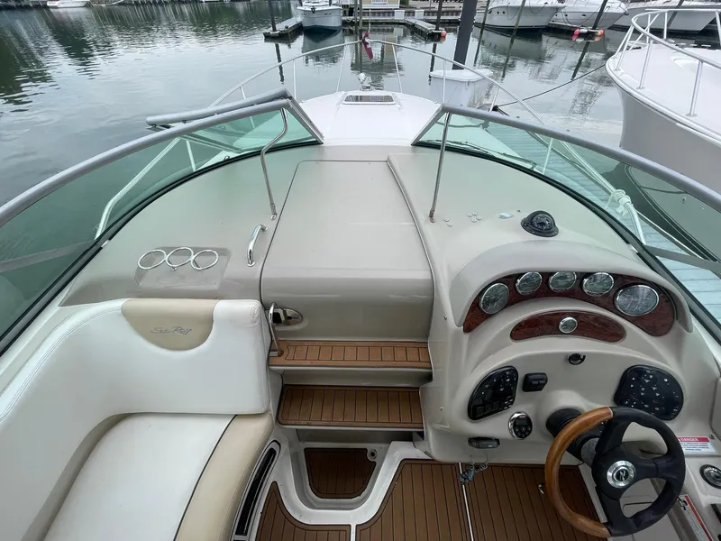 Slide: The Image of 2008 Sea Ray 280 Sundancer cockpit with wood accents and marina view. - 7