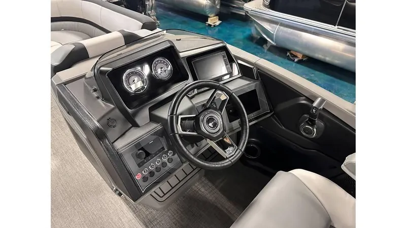 Slide: The Image of 2025 Tahoe Pontoon Cascade Cruise Rear Bench dashboard with modern controls and steering wheel. - 24
