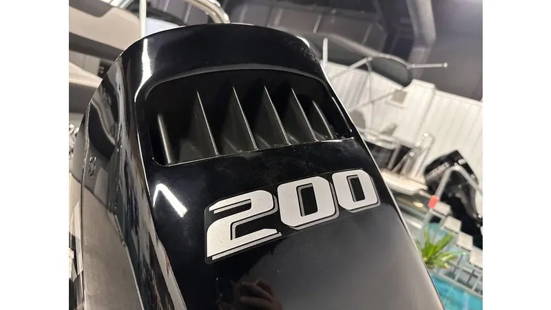 Slide: The Image of Close-up of a 200 horsepower engine on a 2025 Tahoe Pontoon Cascade Cruise Rear Bench. - 26