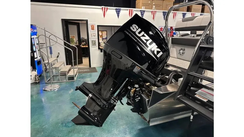 Slide: The Image of 2025 Tahoe Pontoon Cascade Cruise with Suzuki outboard motor in showroom. - 27