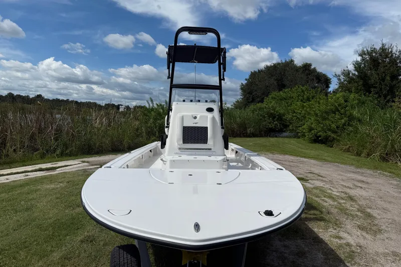 Slide: The Image of 2025 Tidewater 25 TPC Raptor boat on grassy terrain under blue sky. - 11