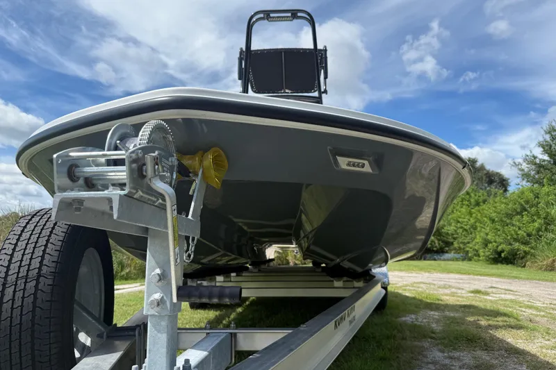 Slide: The Image of 2025 Tidewater 25 TPC Raptor boat on trailer under blue sky. - 12