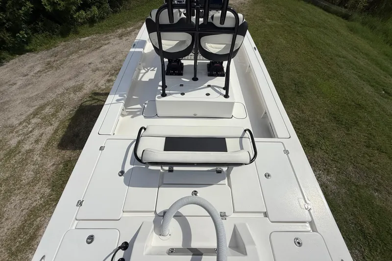 Slide: The Image of 2025 Tidewater 25 TPC Raptor boat interior, featuring seating and storage compartments. - 13