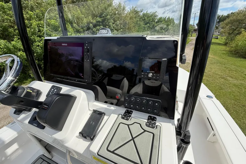 Slide: The Image of 2025 Tidewater 25 TPC Raptor boat dashboard with advanced navigation and control systems. - 17