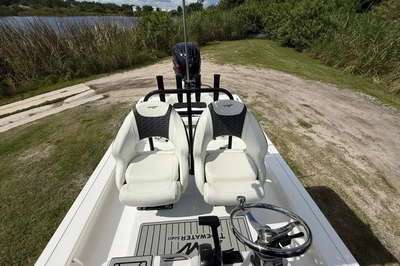 Slide: The Image of 2025 Tidewater 25 TPC Raptor boat interior with dual seats and steering wheel. - 25