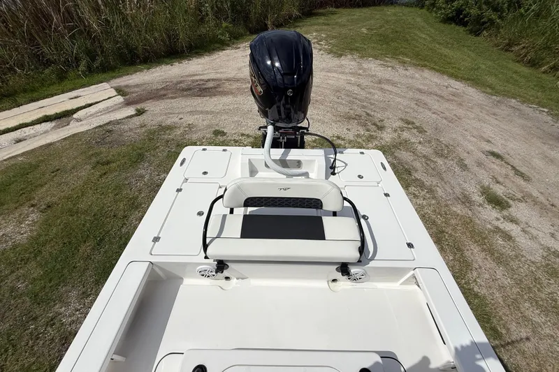 Slide: The Image of 2025 Tidewater 25 TPC Raptor boat with outboard motor on grassy terrain. - 26