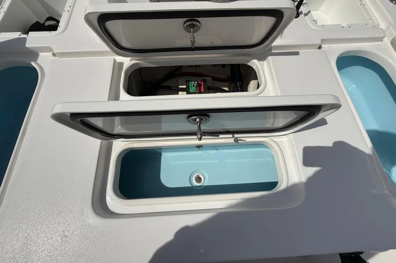 Slide: The Image of 2025 Tidewater 25 TPC Raptor boat storage compartments with open lids and visible interior. - 31