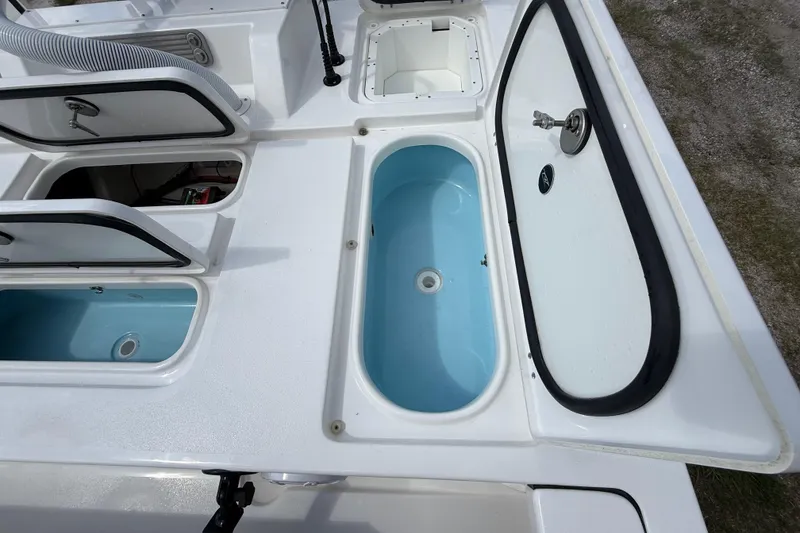 Slide: The Image of 2025 Tidewater 25 TPC Raptor boat deck with storage compartments and livewell. - 33