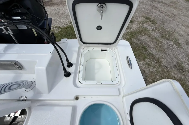 Slide: The Image of 2025 Tidewater 25 TPC Raptor boat storage compartment and engine detail. - 34