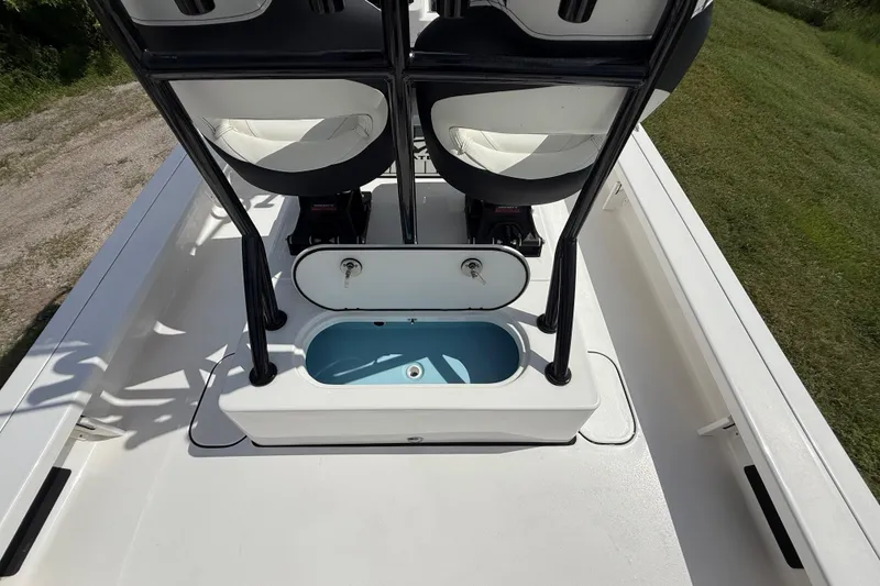 Slide: The Image of 2025 Tidewater 25 TPC Raptor boat interior with seating and storage compartment. - 36