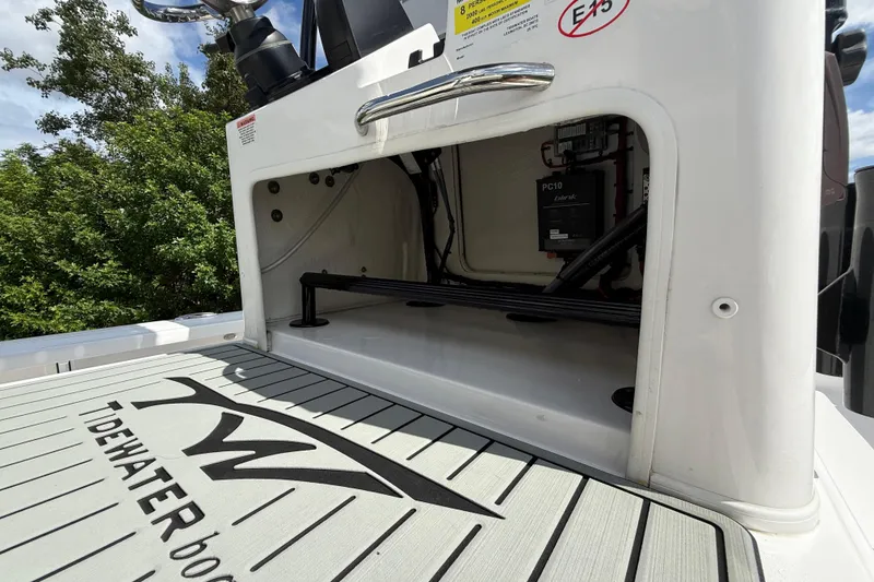 Slide: The Image of 2025 Tidewater 25 TPC Raptor boat interior compartment with visible wiring and logo. - 39