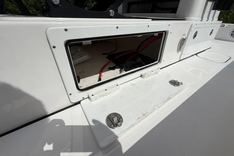 Slide: The Image of 2025 Tidewater 25 TPC Raptor boat storage compartment with open hatch and visible wiring. - 41