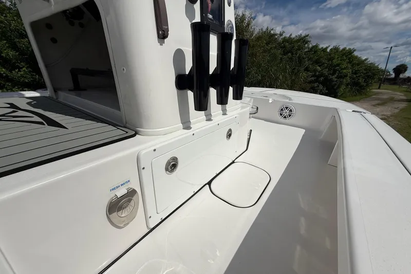 Slide: The Image of 2025 Tidewater 25 TPC Raptor boat interior with rod holders and fresh water access. - 42