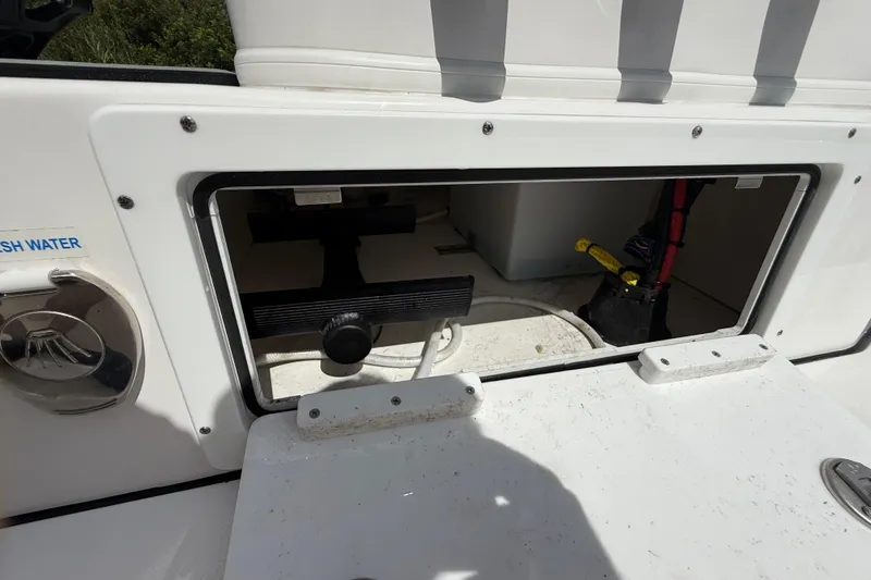 Slide: The Image of 2025 Tidewater 25 TPC Raptor boat compartment with fresh water access and storage. - 43