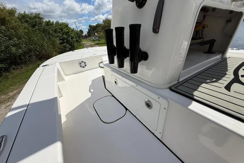 Slide: The Image of 2025 Tidewater 25 TPC Raptor boat deck with rod holders and storage compartments. - 47