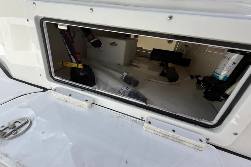 Slide: The Image of Storage compartment of 2025 Tidewater 25 TPC Raptor boat, showing equipment and wiring. - 48