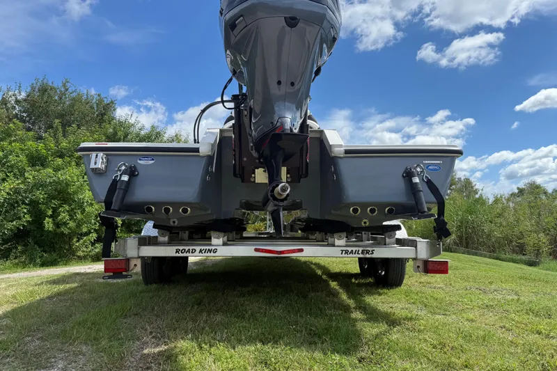 Slide: The Image of 2025 Tidewater 25 TPC Raptor boat on trailer, rear view, outdoors. - 7