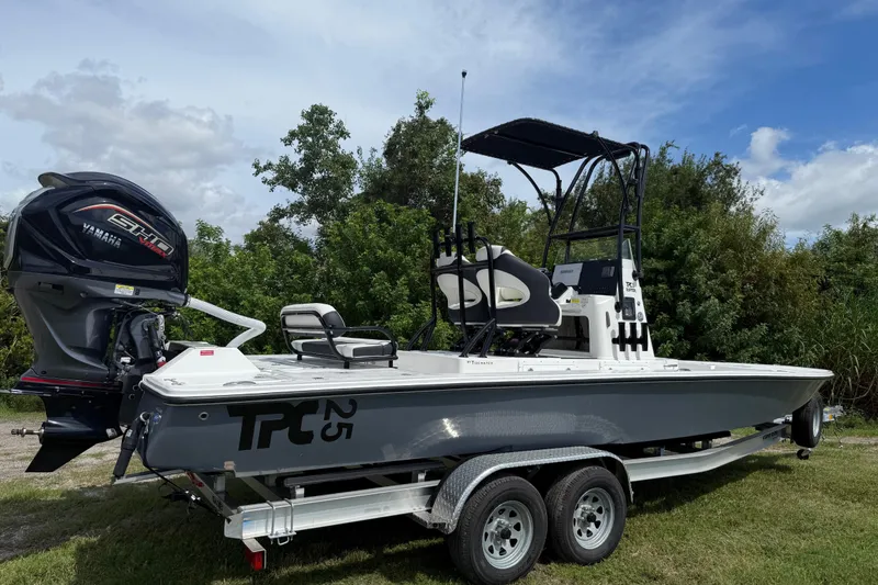 Slide: The Image of 2025 Tidewater 25 TPC Raptor boat on trailer, featuring Yamaha engine, outdoors. - 8