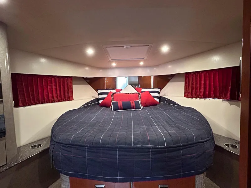 Slide: The Image of Luxurious cabin interior of a 2007 Formula 40 PC yacht with plush bedding and red accents. - 19