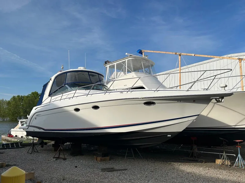 Slide: The Image of 2007 Formula 40 PC yacht on dry dock, white hull, clear sky background. - 2
