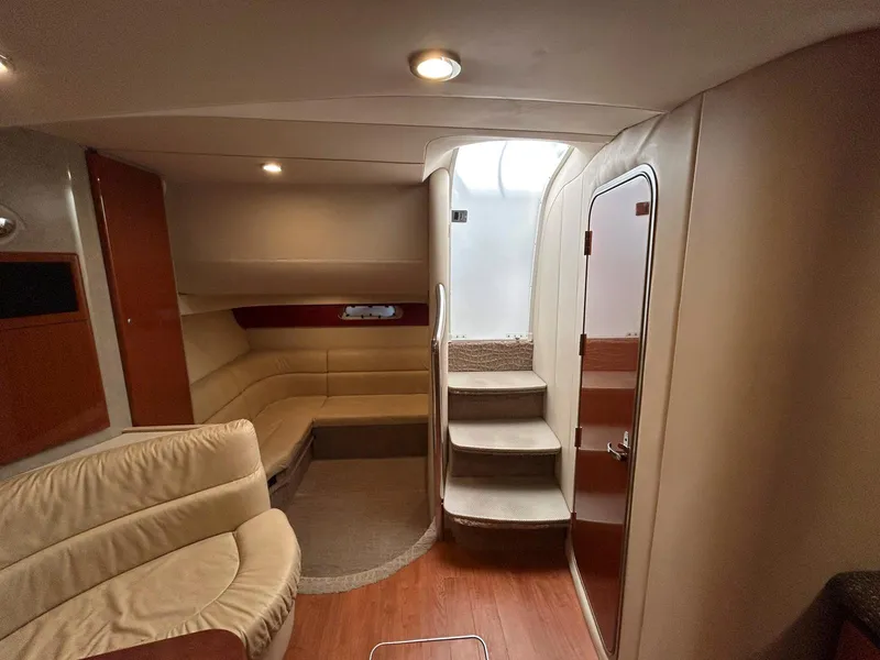 Slide: The Image of 2007 Formula 40 PC yacht interior with beige seating, wooden flooring, and stairway. - 23