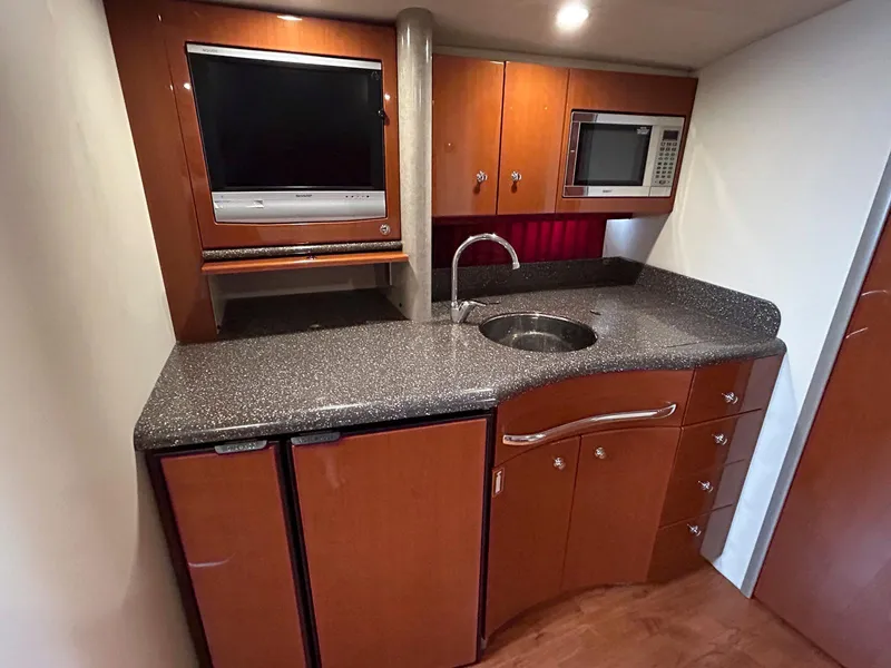 Slide: The Image of 2007 Formula 40 PC yacht kitchen with TV, microwave, and sleek cabinetry. - 29