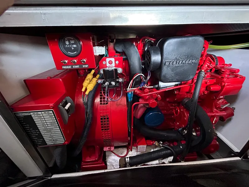 Slide: The Image of Engine compartment of a 2007 Formula 40 PC boat, featuring a red Westerbeke generator. - 38