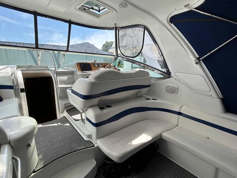 Slide: The Image of 2007 Formula 40 PC yacht interior with white seating and blue accents. - 8