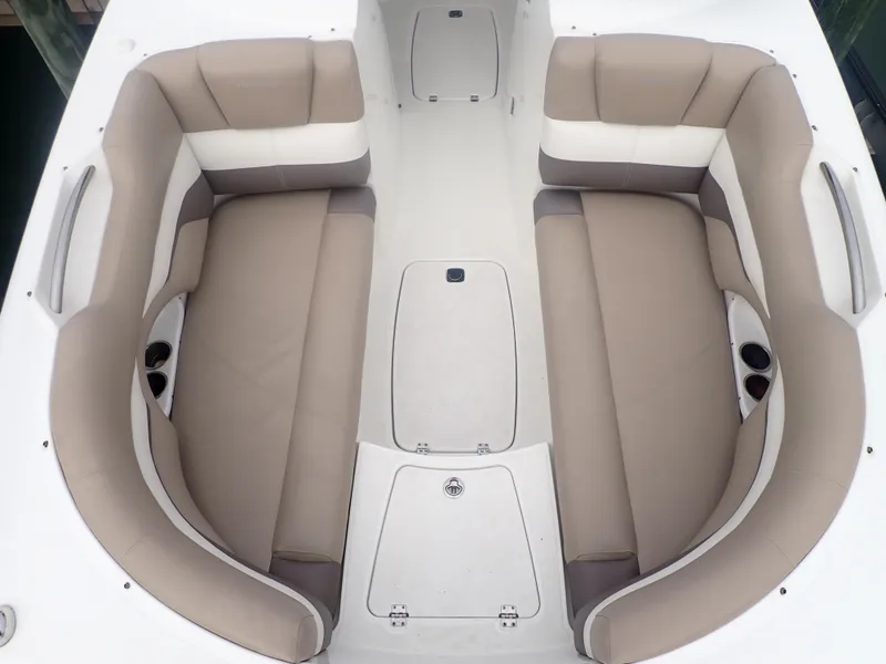 Slide: The Image of 2016 Hurricane SunDeck 2690 OB boat interior with beige seating and cup holders. - 10