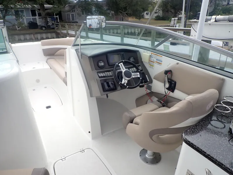 Slide: The Image of 2016 Hurricane SunDeck 2690 OB boat interior with steering console and seating. - 11