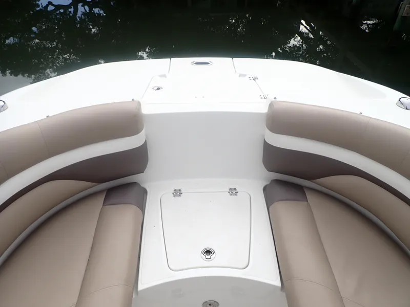 Slide: The Image of 2016 Hurricane SunDeck 2690 OB boat interior with beige seating and storage compartment. - 17