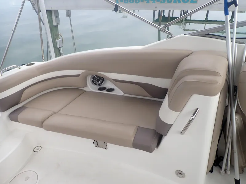 Slide: The Image of 2016 Hurricane SunDeck 2690 OB boat interior with beige seating and speaker. - 18
