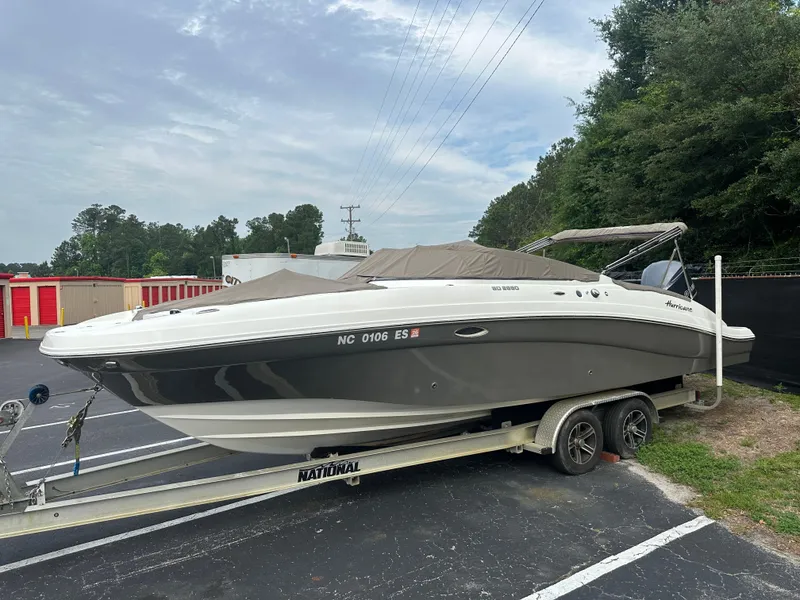 Slide: The Image of 2016 Hurricane SunDeck 2690 OB boat on trailer in parking lot. - 2