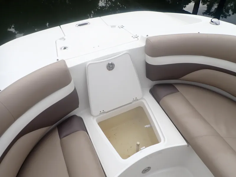 Slide: The Image of 2016 Hurricane SunDeck 2690 OB boat interior with open storage compartment and cushioned seating. - 20