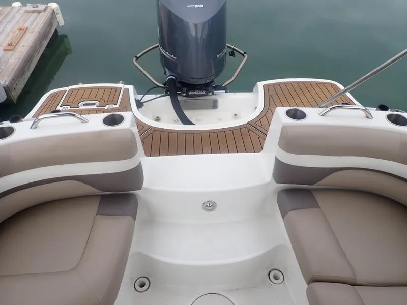 Slide: The Image of 2016 Hurricane SunDeck 2690 OB boat interior with seating and outboard motor. - 23
