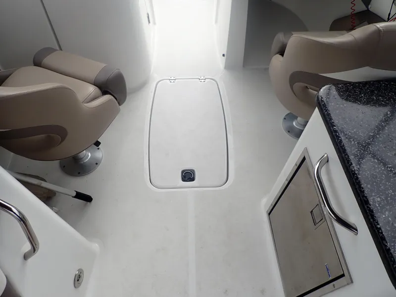 Slide: The Image of Interior of 2016 Hurricane SunDeck 2690 OB boat with seating and storage compartments. - 26