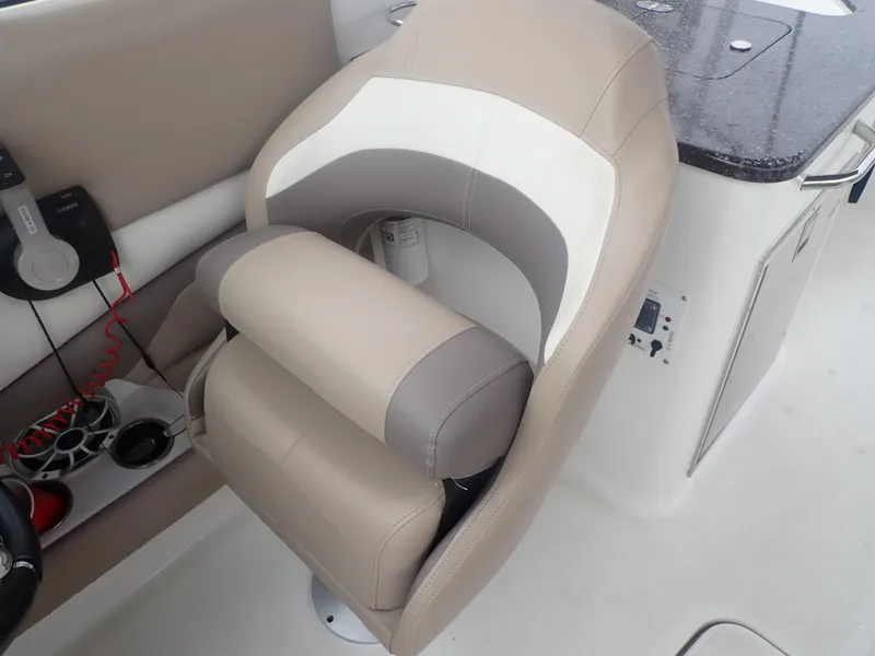 Slide: The Image of 2016 Hurricane SunDeck 2690 OB boat seat with beige and white upholstery. - 30
