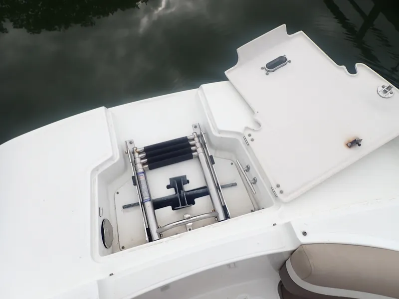 Slide: The Image of 2016 Hurricane SunDeck 2690 OB boat with open storage compartment and ladder. - 35