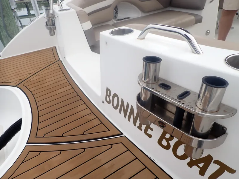 Slide: The Image of 2016 Hurricane SunDeck 2690 OB boat deck with teak flooring and seating area. - 39