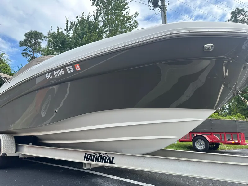 Slide: The Image of 2016 Hurricane SunDeck 2690 OB boat on trailer, side view, outdoors. - 4