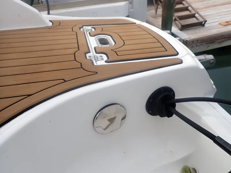 Slide: The Image of 2016 Hurricane SunDeck 2690 OB boat deck with wood finish and fuel cap. - 40