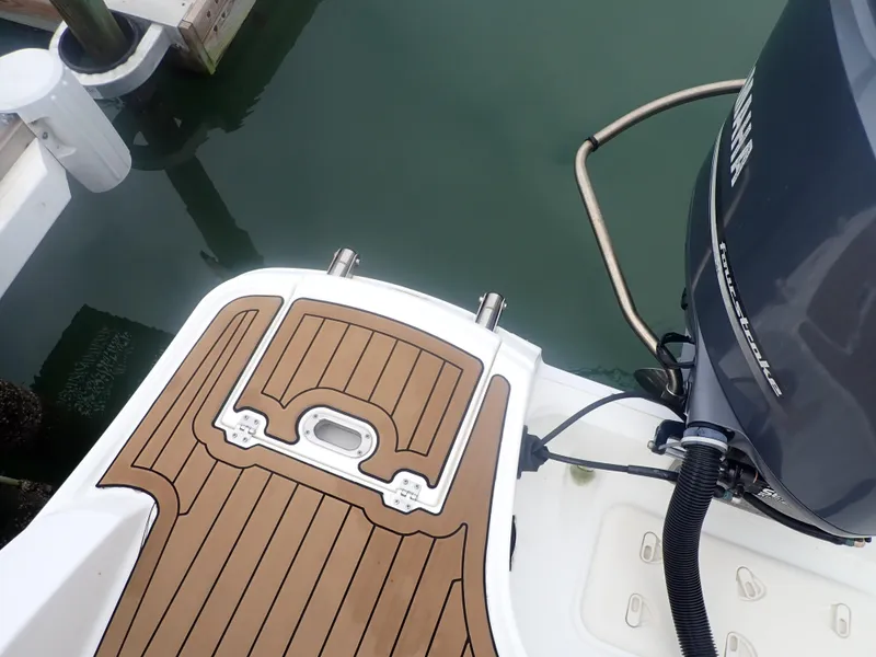 Slide: The Image of 2016 Hurricane SunDeck 2690 OB boat with Yamaha outboard motor and teak-style deck. - 41
