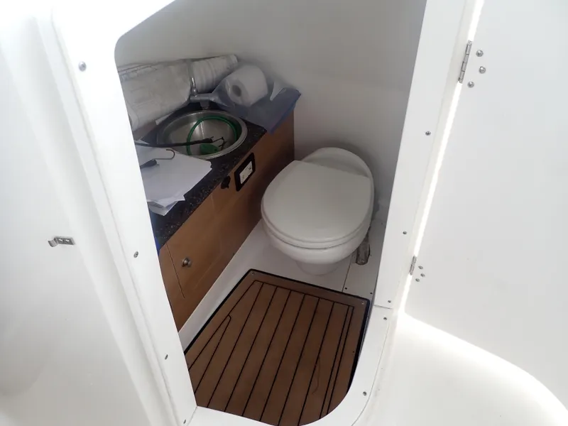 Slide: The Image of 2016 Hurricane SunDeck 2690 OB boat bathroom with toilet and sink. - 42