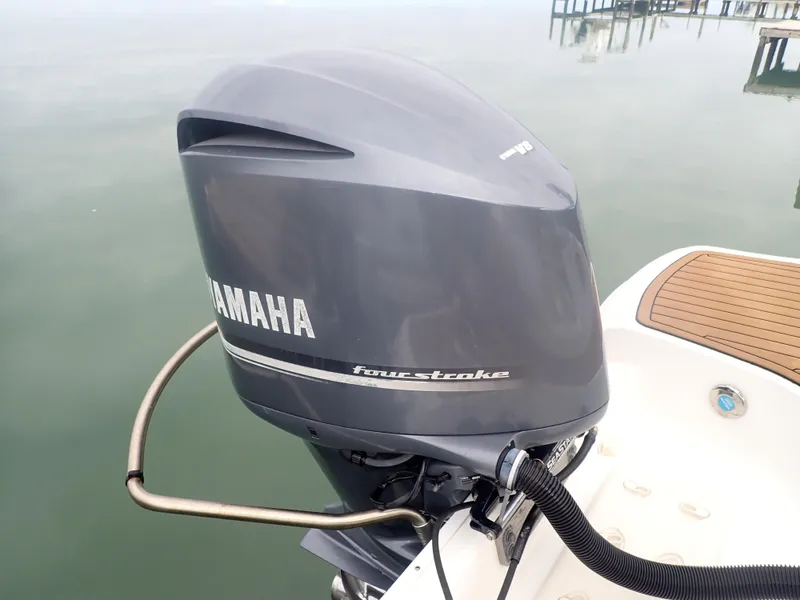 Slide: The Image of 2016 Hurricane SunDeck 2690 OB with Yamaha four-stroke outboard motor on calm water. - 44
